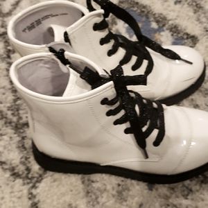 Children place white boot